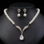 Pearl-style necklace with clear teardrop pendant and matching earrings on a black bust