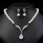 Pearl-style necklace with clear teardrop pendant and matching earrings on a black bust