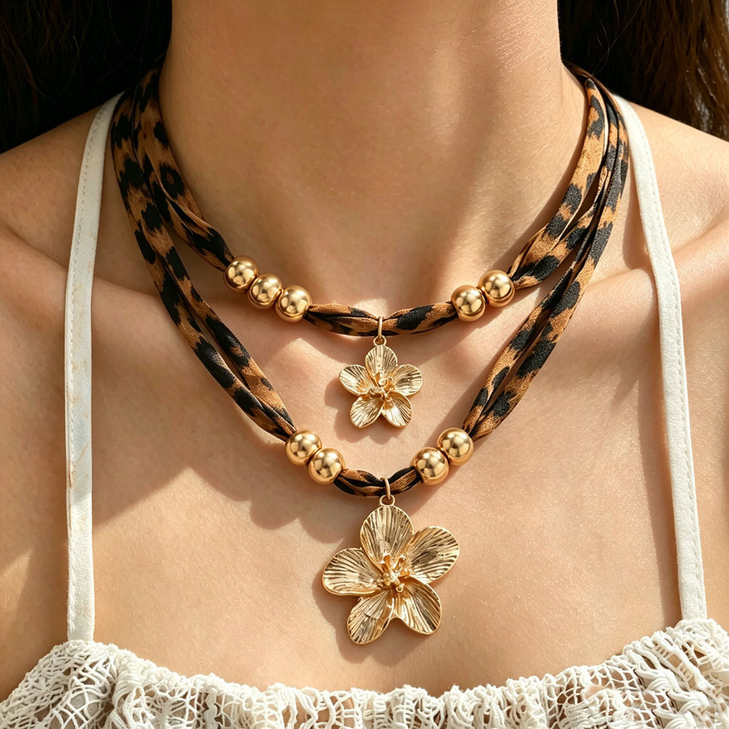 Layered leopard-print cord necklace with gold-tone beads and two flower pendants