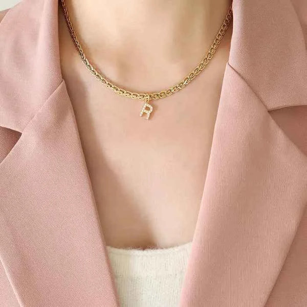 Letter pendant necklace in brass with zircon inlay — primary view