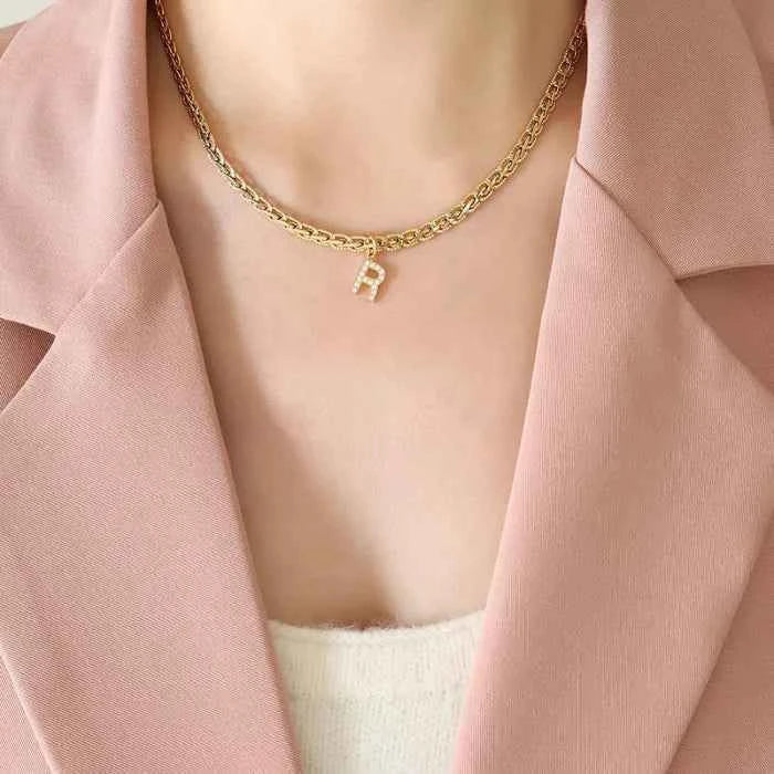 Letter pendant necklace in brass with zircon inlay — primary view Main image