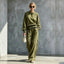 Olive green button-neck top and wide-leg pants set with striped trim, worn by a model