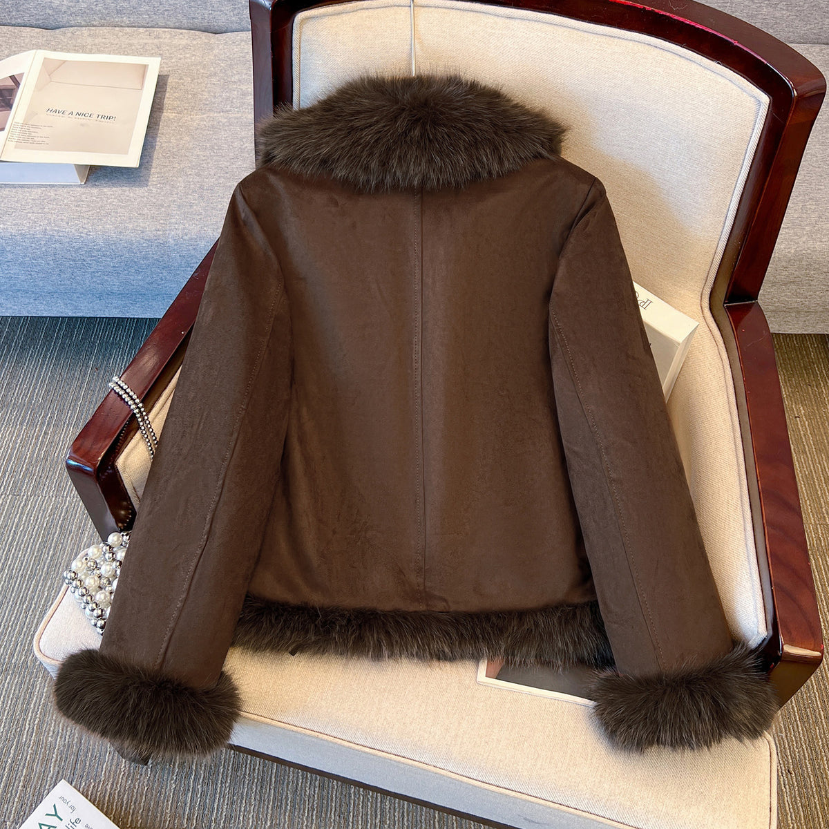 Brown cropped coat with dark plush collar and hem, back view