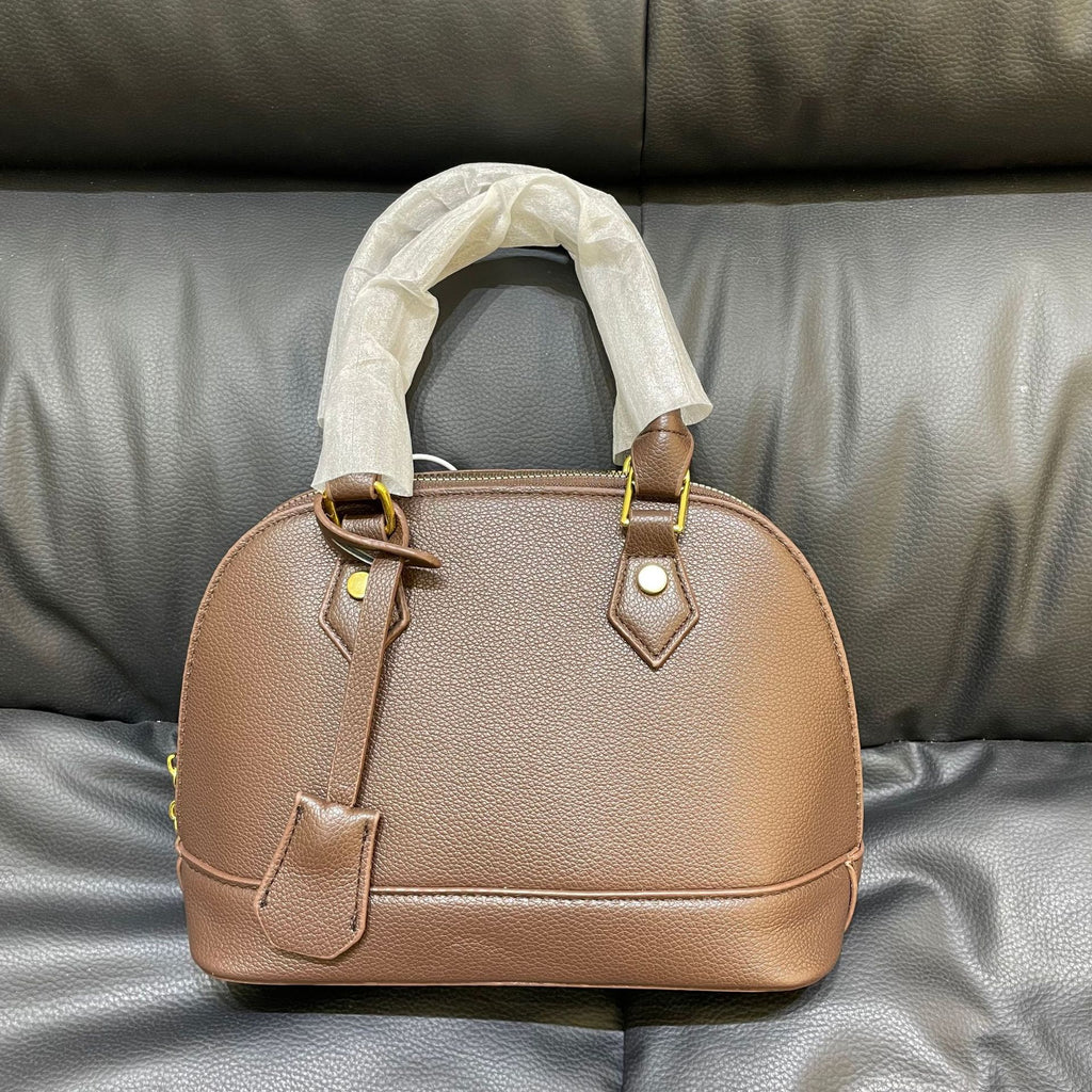 Shell crossbody bag shown from side angle