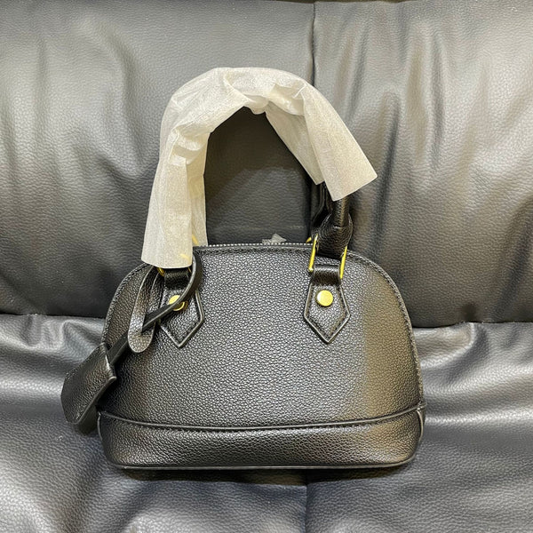 Shell crossbody bag shown on shoulder
