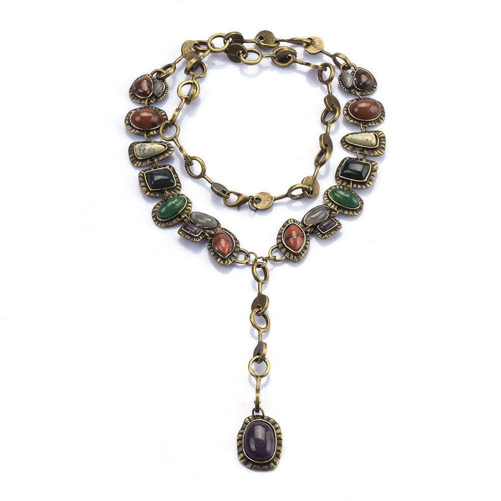 Layered necklace with multicolor oval accents and long drop pendant on white