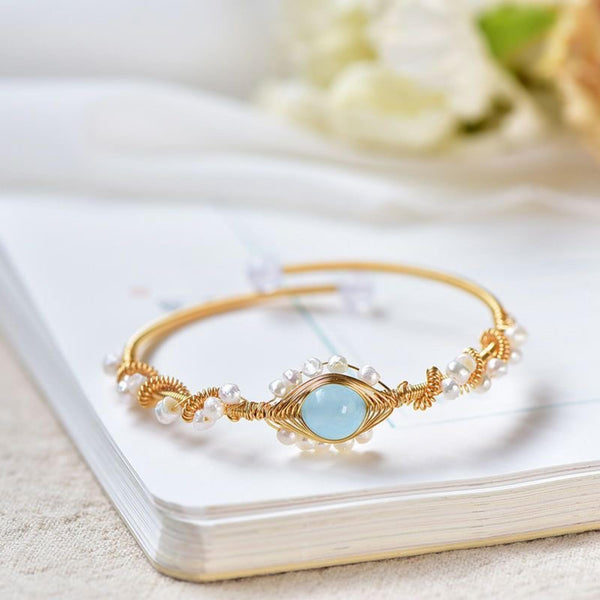 Main product photo of Gold Tone Pearl Braided Bracelet, gold tone pearl braided bracelet