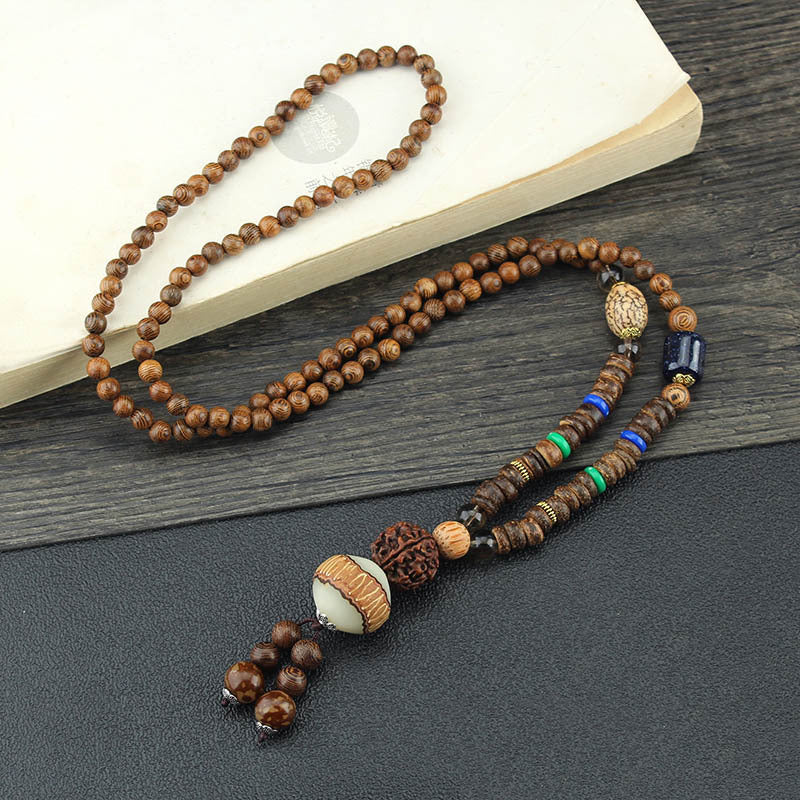 Long brown beaded necklace with round striped pendant and multicolor disc accents