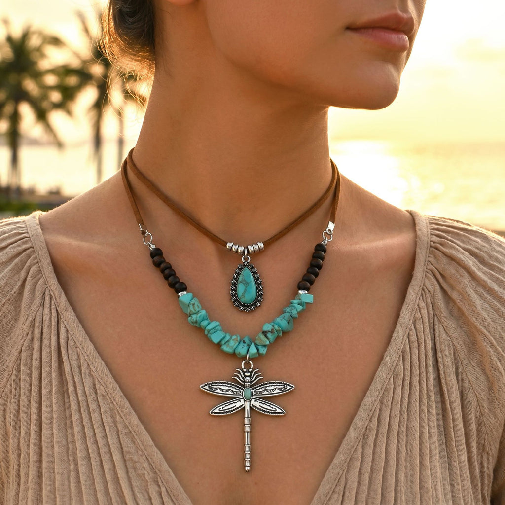 Layered necklaces with turquoise-colored beads, teardrop accent and dragonfly pendant