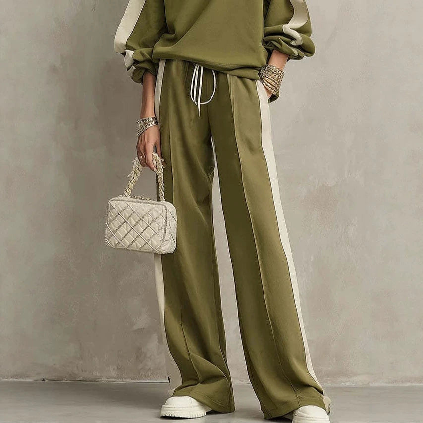 Olive wide-leg drawstring pants with cream side panels, worn by a model