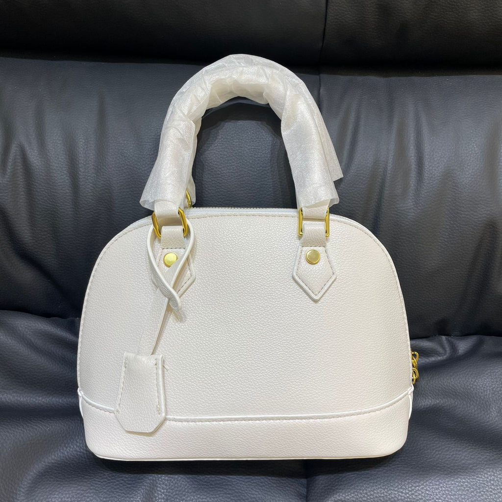 Shell crossbody bag shown in a different color