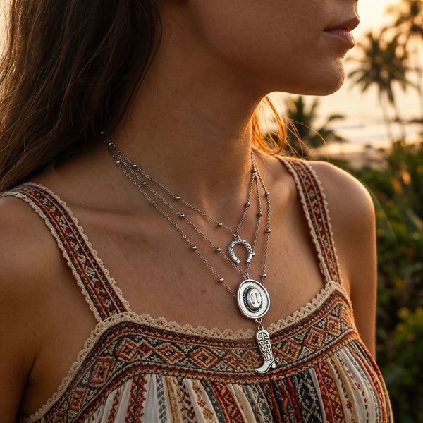 Layered silver-tone necklaces with round and elongated drop pendants