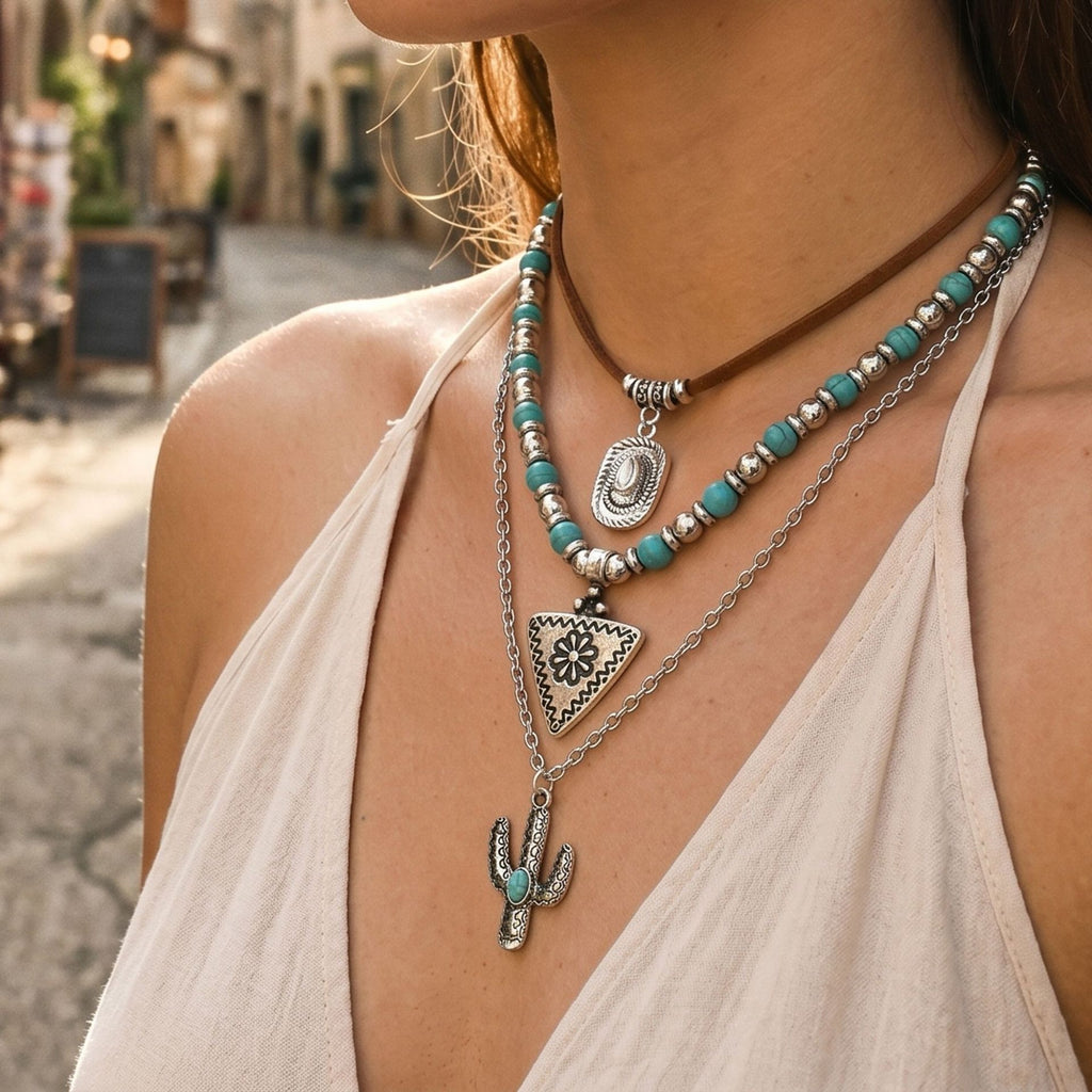 Turquoise-colored beaded necklace with layered geometric silver-tone pendants