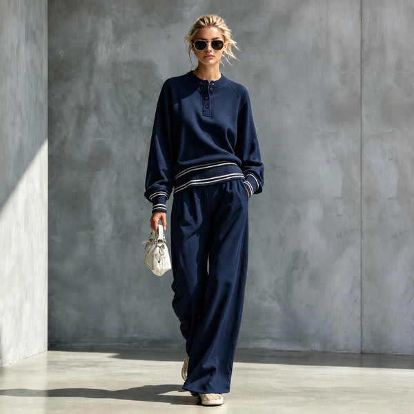 Navy button-neck top and wide-leg pants set with striped trim, worn by a model