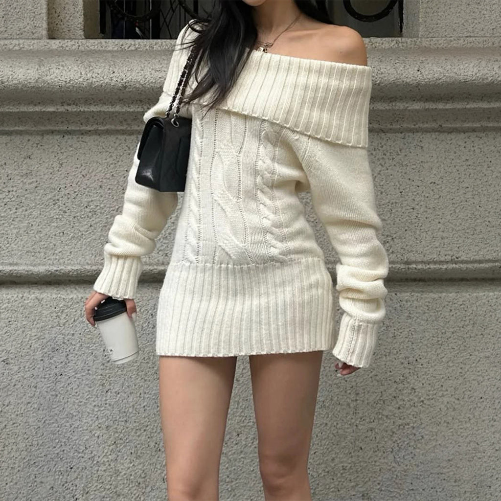 Cream off-shoulder cable-knit mini dress, front view beside stone steps