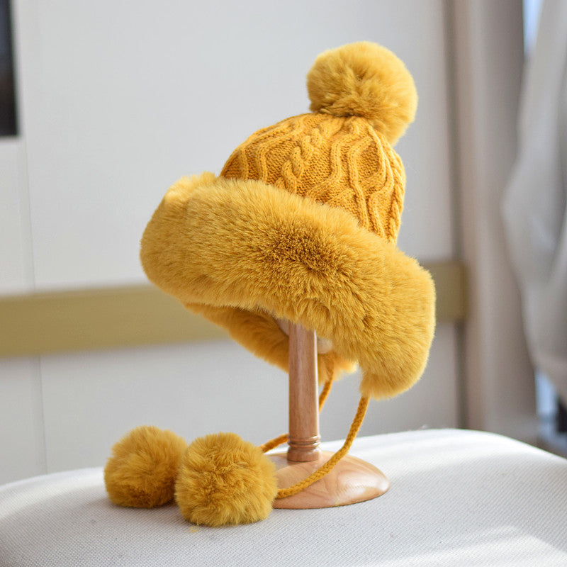 Yellow pom-pom lace-up winter hat for women