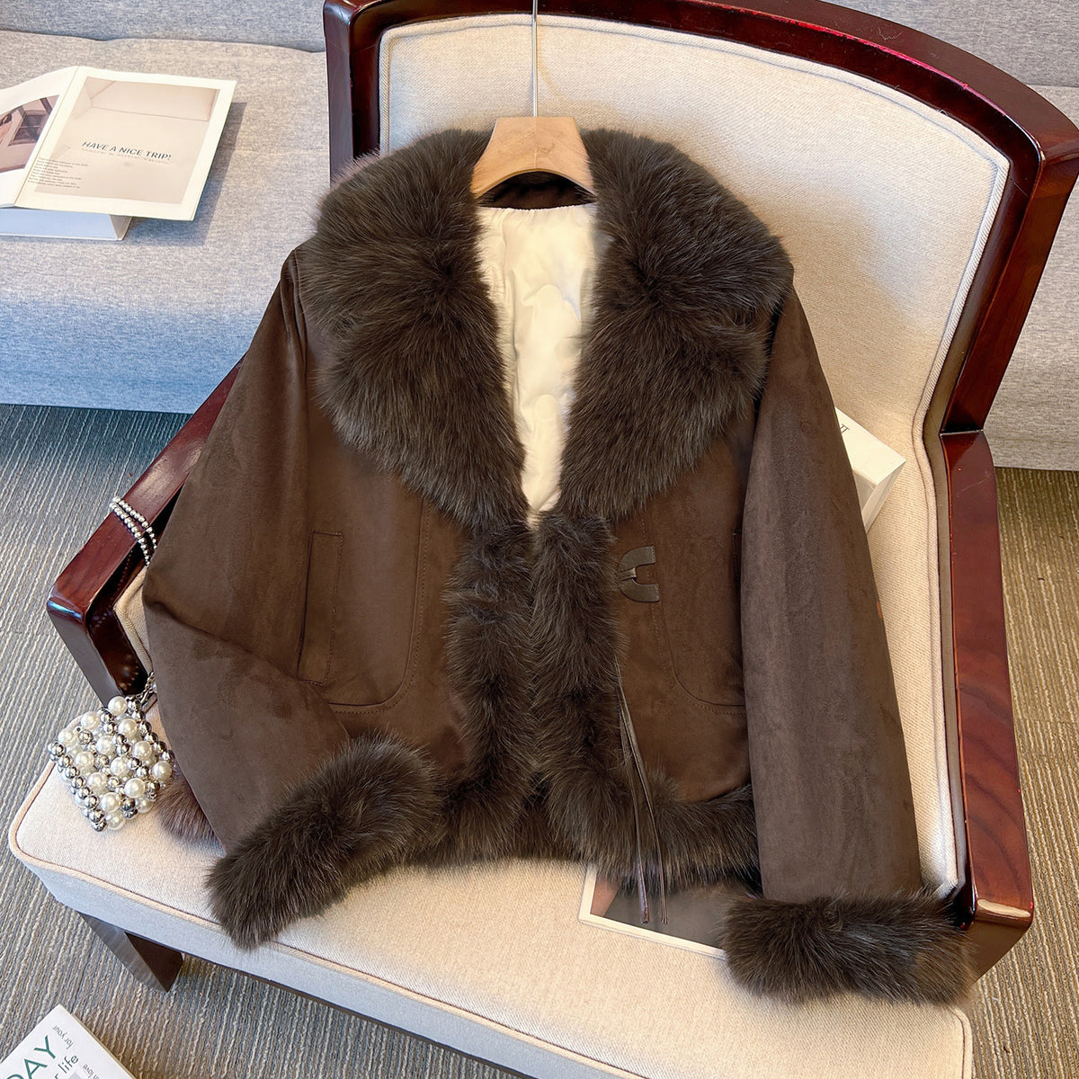 Brown cropped coat with dark plush collar and cuffs, displayed on a hanger