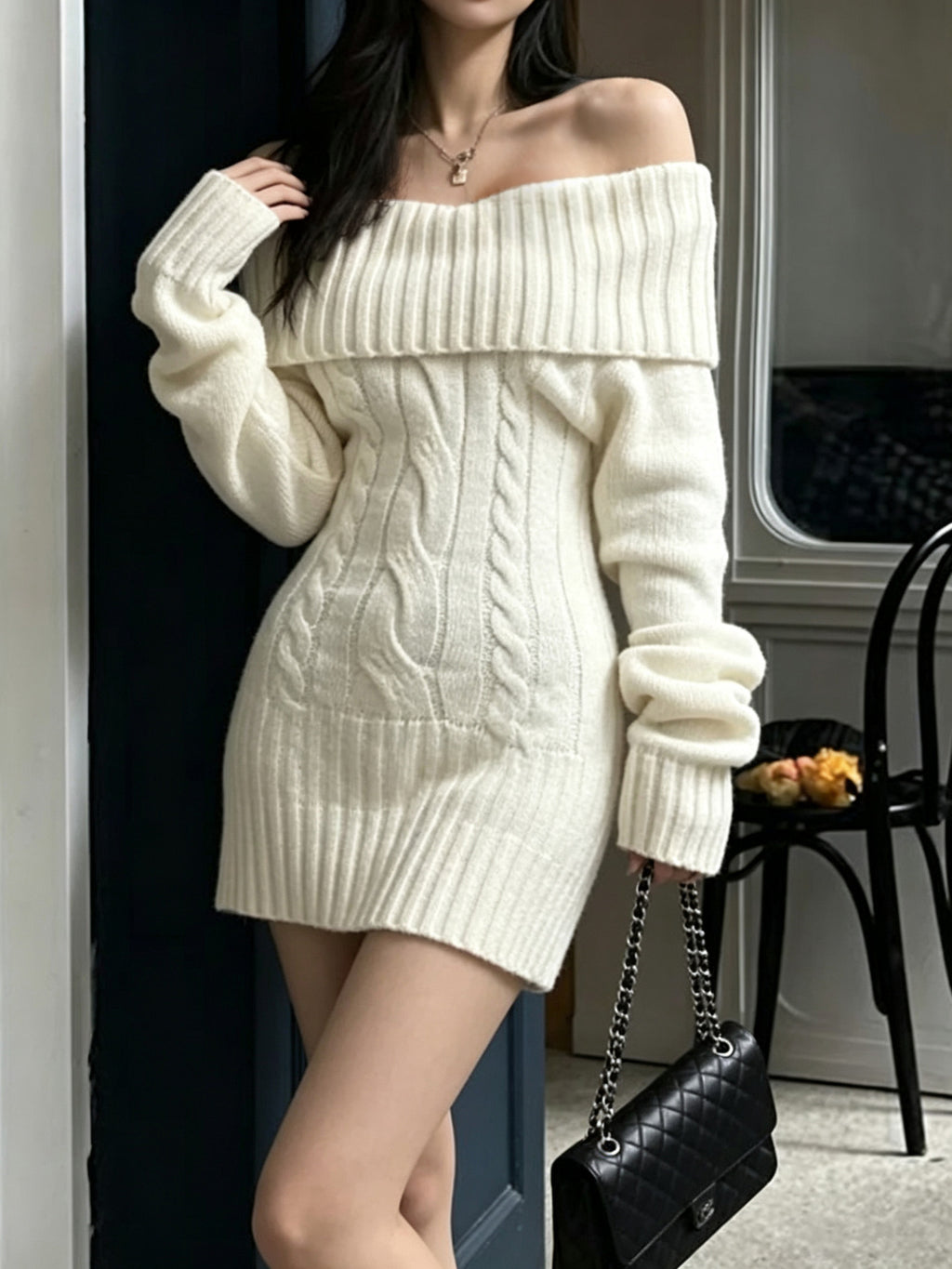 Cream cable-knit mini sweater dress with long sleeves, worn by a model