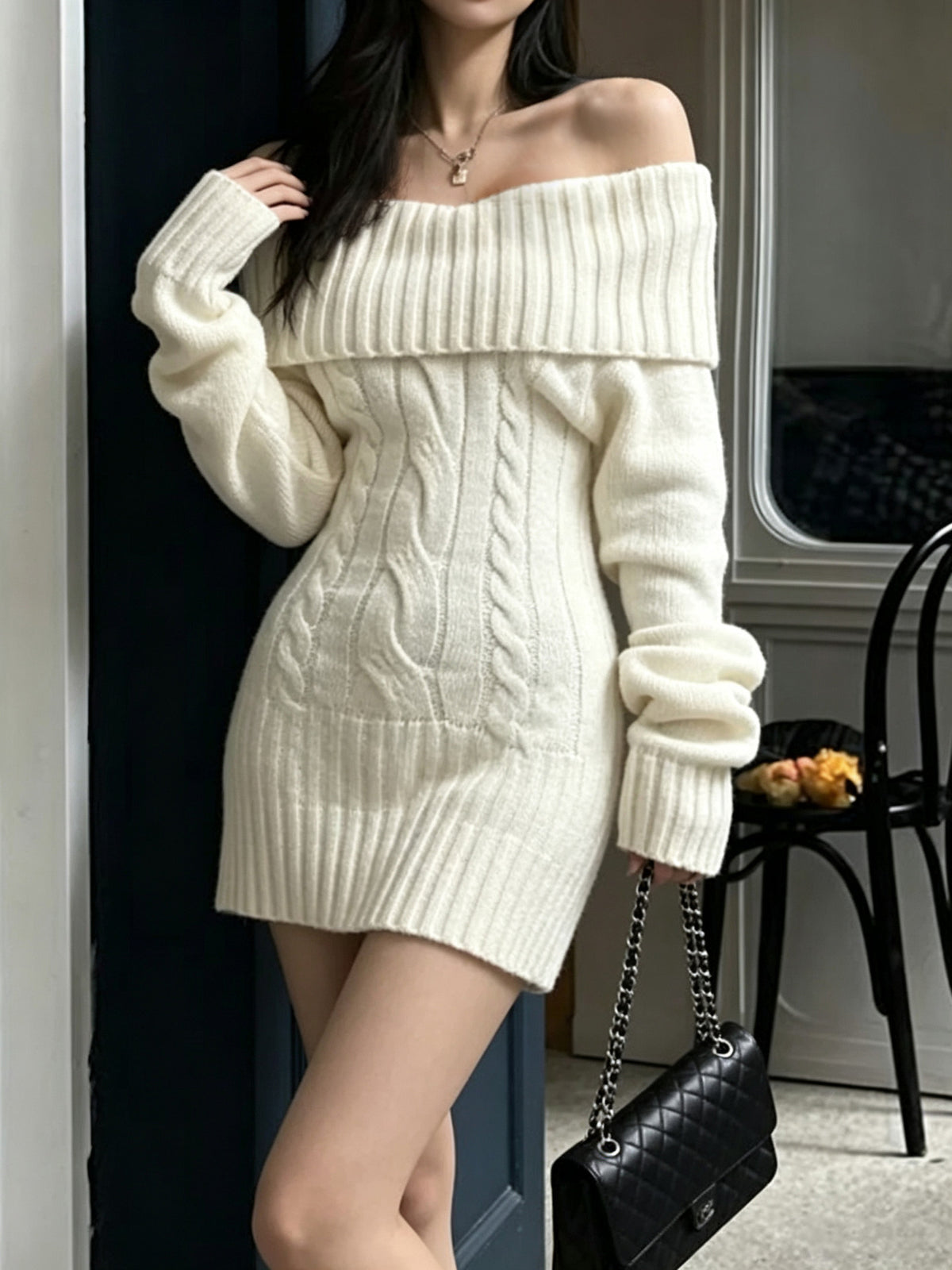 Cream cable-knit mini sweater dress with long sleeves, worn by a model