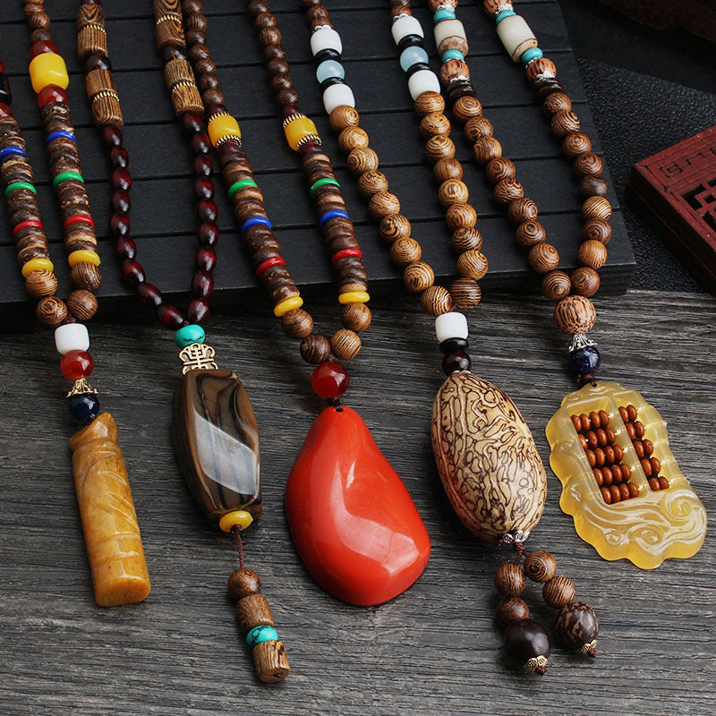 Long wooden-style beaded necklaces with assorted colorful beads and pendants