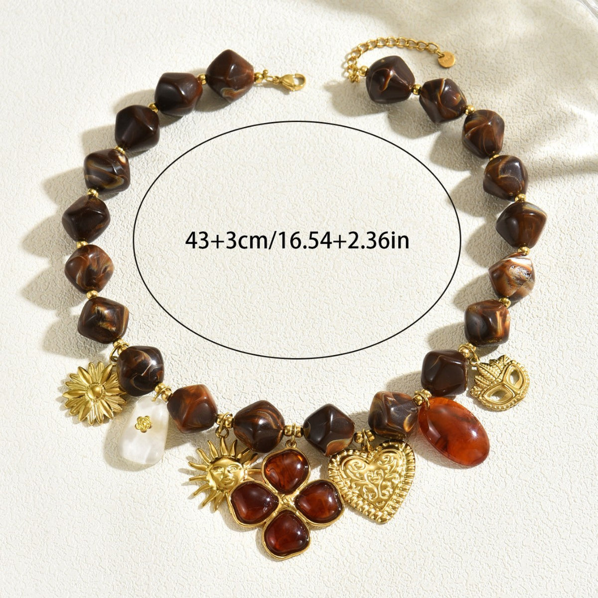 Brown beaded necklace with heart and flower charms and a length measurement guide