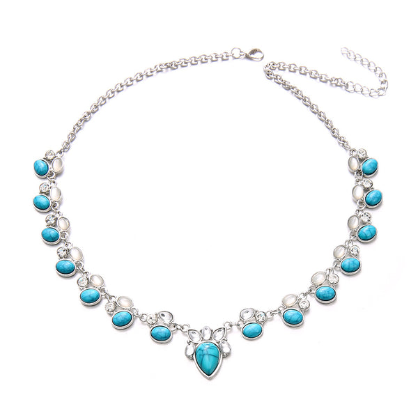 Silver-tone necklace with alternating clear and turquoise-colored teardrop accents
