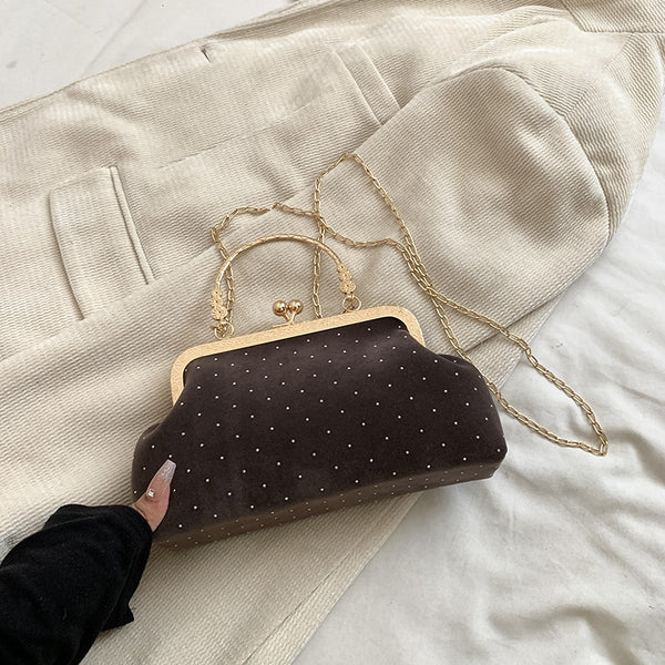 Shell crossbody bag shown from side angle