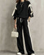 Black sweatshirt and wide-leg pants set with cream contrast panels, worn by a model