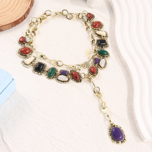 Gold-tone layered necklace with multicolor oval accents and purple drop pendant