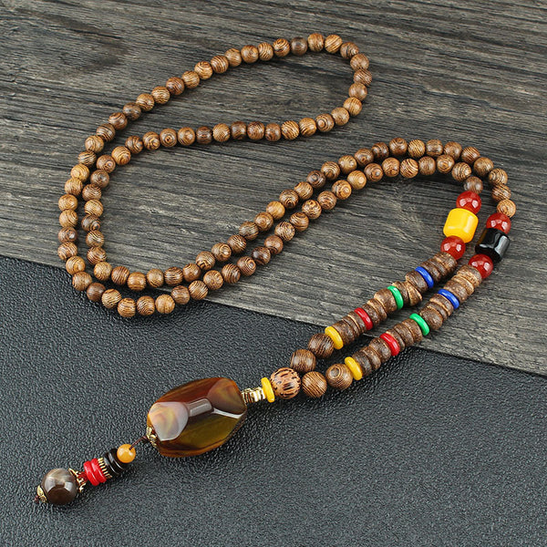 Brown beaded necklace with multicolor disc beads and an amber-colored drop pendant