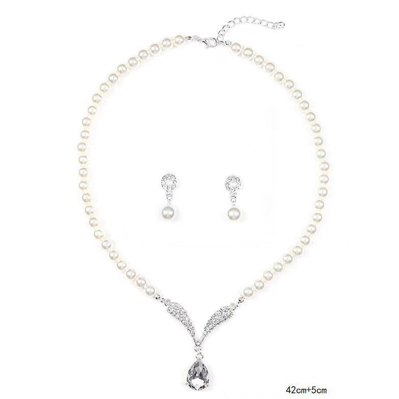 White pearl-style necklace and matching drop earrings on a white background