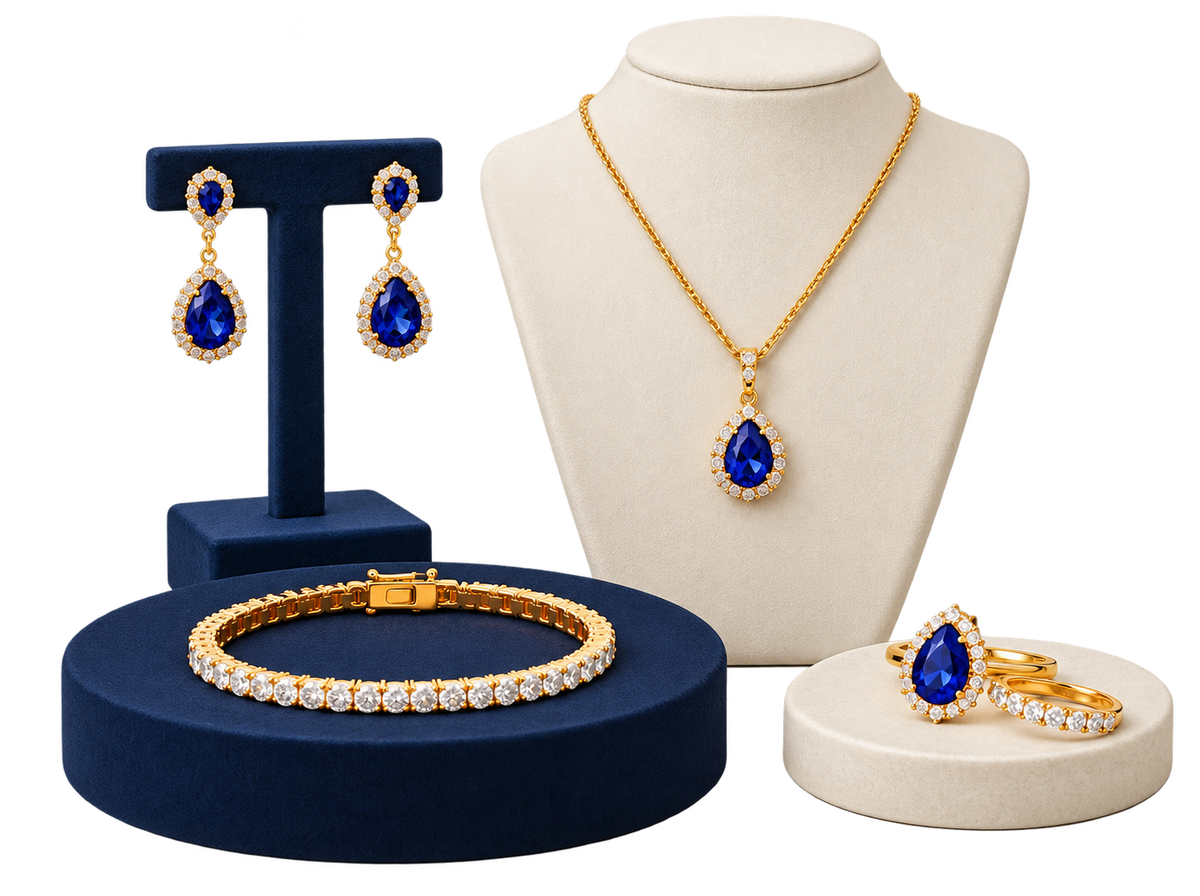Blue and gold-tone necklace, earrings, bracelet and rings on display